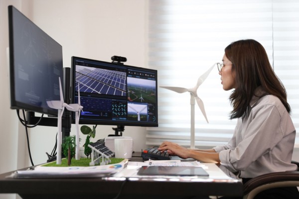 The construction industry has faced multiple challenges in 2024 and builders have looked at different product offerings, promotion and incentives. Image of young woman with black hair and glasses working on a sustainable construction design on her computer. 