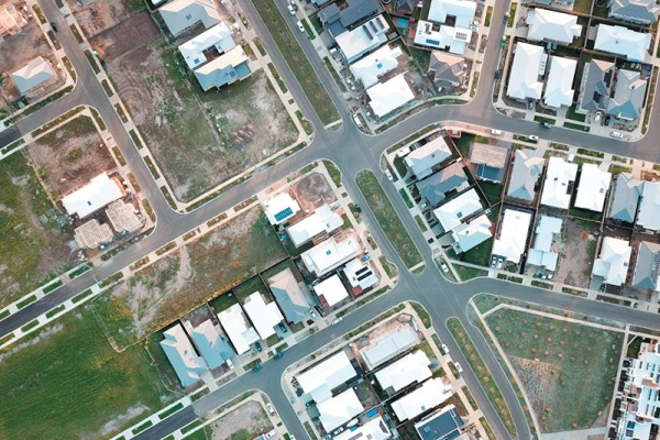 Image alt text: A highly targeted property development marketing strategy can generate4 excellent ROI. Image of a property development aerial view including houses and vacant lots. 