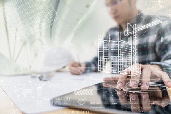 Urban planners in Victoria are frustrated by the lengthy PSP process. Image of urban planner at work. His hand is on a tablet in the foreground with design sketches overlaying the image. 